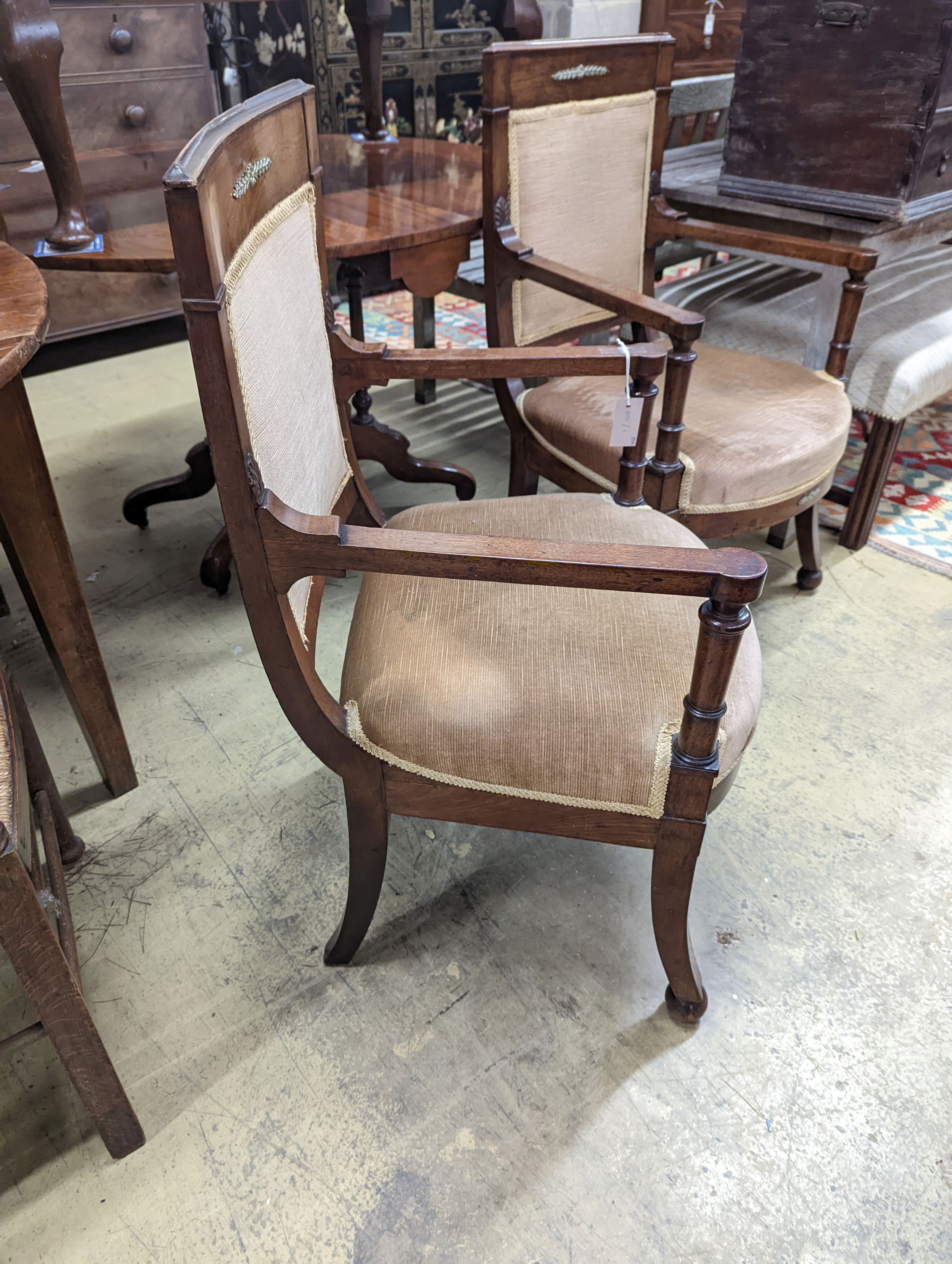 A pair of French Empire style mahogany gilt metal mounted elbow chairs, width 54cm, depth 50cm, height 96cm